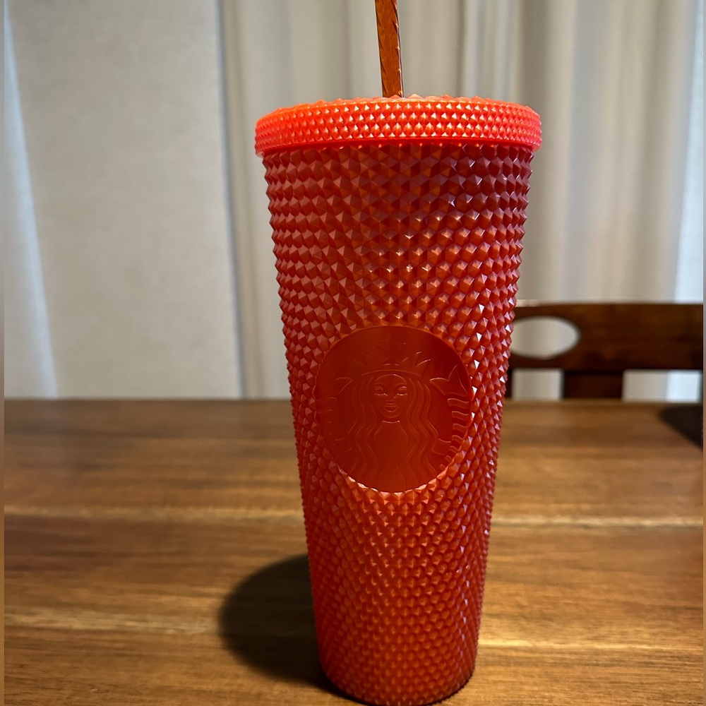 Orange studded Starbucks tumbler